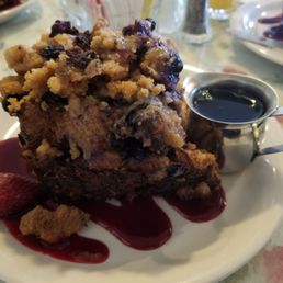 The giant Oven Baked French Toast is layered with cinnamon rolls, Texas toast, croissants, blueberries, raspberries, & topped with streusel The giant Oven Baked French Toast is layered with cinnamon rolls, Texas toast, croissants, blueberries, raspberries, & topped with streusel
