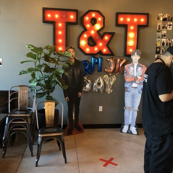 Tea & Tea - two people standing in front of a large t and t sign - Bubble Tea Near Me - Portland, Oregon