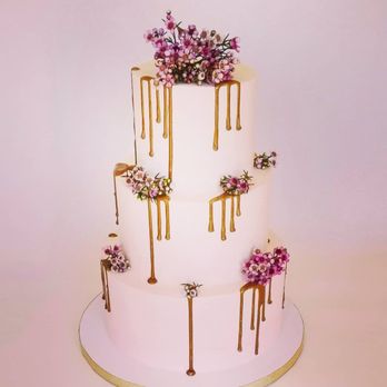 Iced and Dazzle - a three tiered cake with drips and flowers - Custom Cakes Near Me Iced and Dazzle - a three tiered cake with drips and flowers - Custom Cakes Near Me