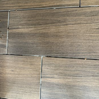 Uncle Mike's Quality Services - 10 SF and other small patch of missed grout for floor replacement - Painters Near Me
