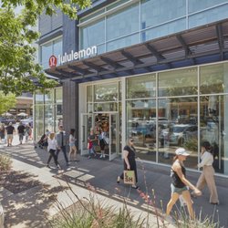 Shoppers walk past the lululemon storefront at SanTan Village.