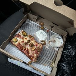 Two Guys Pizza Pies - Small square pizza with jalapeños. Also melted butter on the crust.