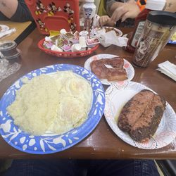 Three eggs over medium, grits, smoked sausage and country ham