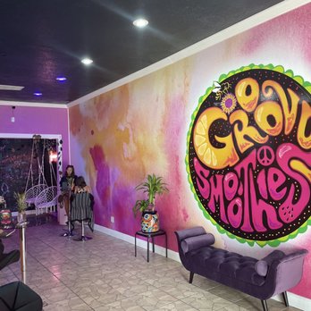 Groovy Smoothies - a woman sitting in a chair in front of a mural - Juice Bars & Smoothies Near Me - Tarpon Springs, Florida Groovy Smoothies - a woman sitting in a chair in front of a mural - Juice Bars & Smoothies Near Me - Tarpon Springs, Florida