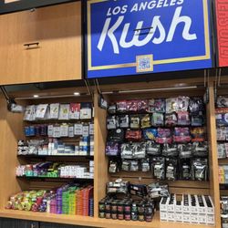 HPC Weed Dispensary - A vibrant Los Angeles Kush (LAK) sign in bold blue with gold lettering, emphasizing their 93x award-winning cannabis.