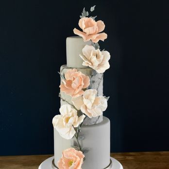 Birch Bakery - a three tiered cake with flowers on top - Custom Cakes Near Me Birch Bakery - a three tiered cake with flowers on top - Custom Cakes Near Me
