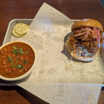 Stonefire Grill - Pulled Pork Sandwich with Stonefire's Beans. The pickle slices missed the paper - American Near Me - Lakewood, California Stonefire Grill - Pulled Pork Sandwich with Stonefire's Beans. The pickle slices missed the paper - American Near Me - Lakewood, California