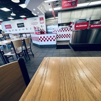 Five Guys - a table and chairs in a fast food restaurant - Burgers Near Me - Knoxville, Tennessee Five Guys - a table and chairs in a fast food restaurant - Burgers Near Me - Knoxville, Tennessee