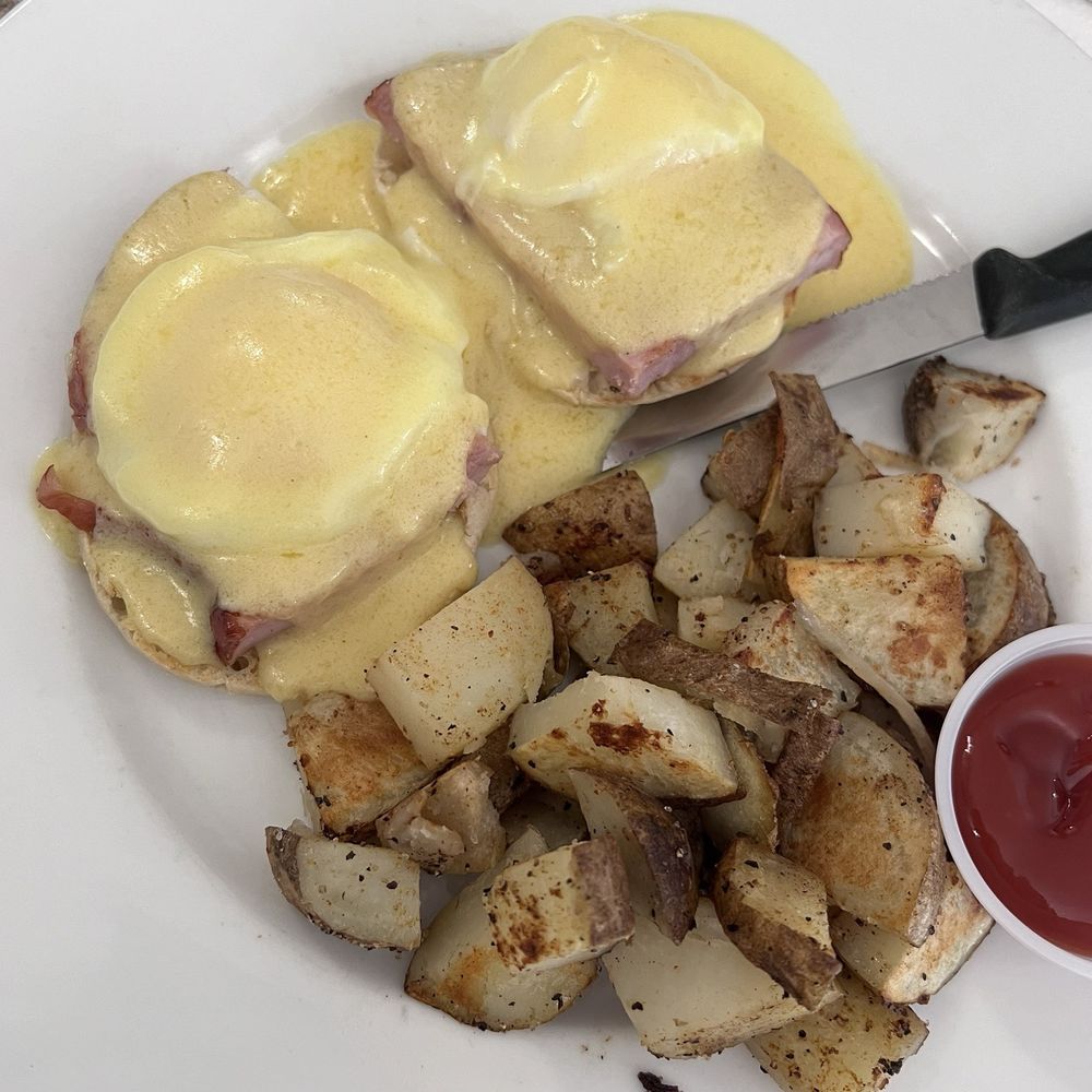 Eggs Benedict and home fries Eggs Benedict and home fries