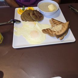Over'easy eggs, sausage, grits, and toast Over'easy eggs, sausage, grits, and toast