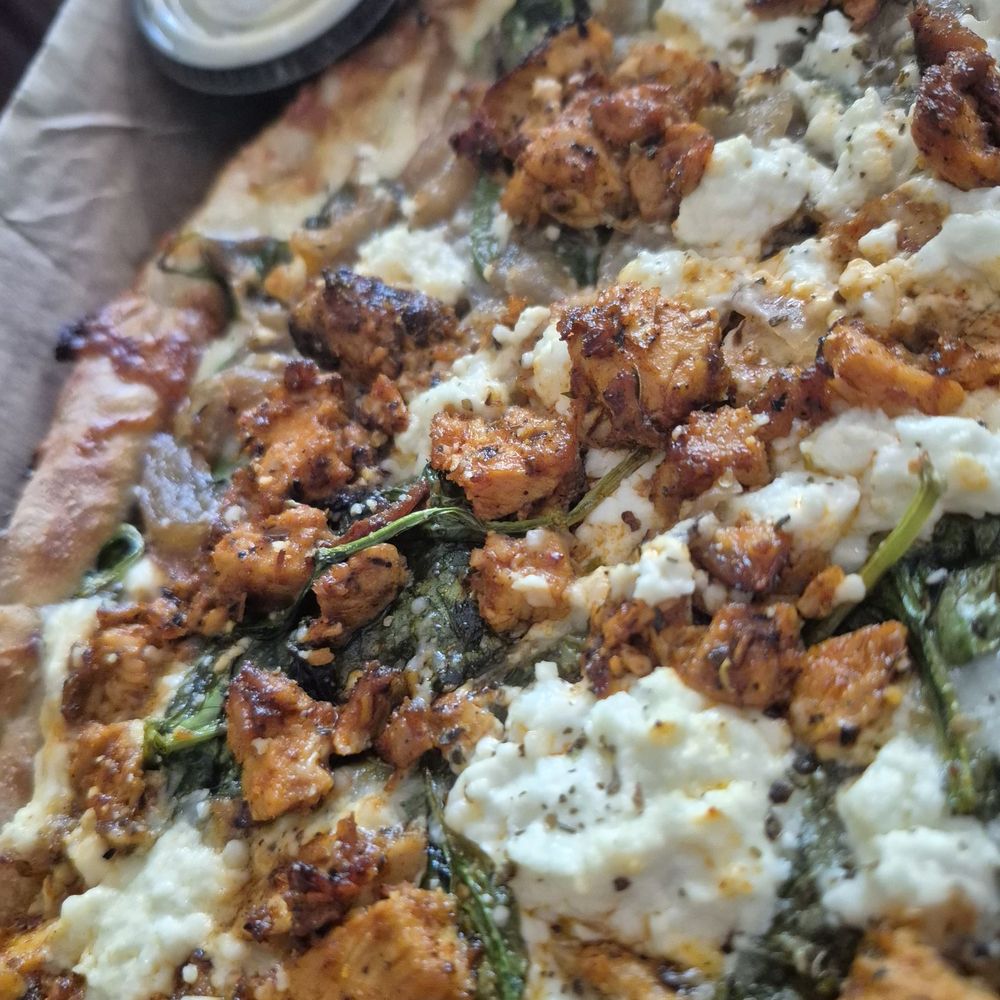 Berbere chicken pizza with goat cheese, sautéed onions and spinach Berbere chicken pizza with goat cheese, sautéed onions and spinach