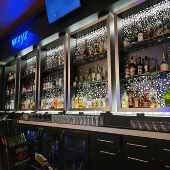 W XYZ Bar - bottles of alcohol on shelves - Cocktail Bars Near Me - Austin, Texas