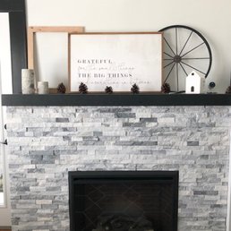 a fireplace with a sign above it