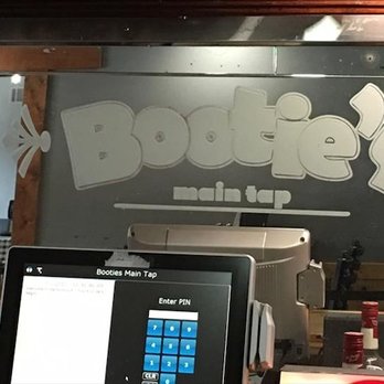 Bootie's Main Tap - a man working on a laptop - Pubs Near Me - Pecatonica, Illinois