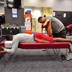 United Wellness & Sports Rehab - Dr H working on a player