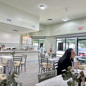 The Salad Station - a woman and a man sitting at a table - Salad Near Me - Irving, Texas