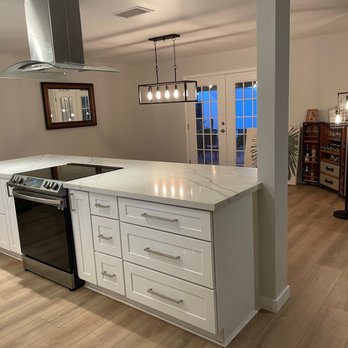 Diversified Remodeling - a kitchen with a stove and island - General Contractors Near Me
