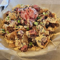 Alumni Grill - Tuna Nachos Grilled tuna, wonton chips, bang bang sauce, spicy teriyaki, pickled ginger, green onions, sesame seeds $16