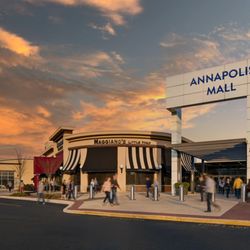 Annapolis Mall - Shoppers enter Annapolis Mall near Maggiano's Little Italy beneath a colorful sunset sky.