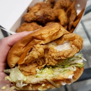 Hi Five Chicken - a hand holding a sandwich - Chicken Shop Near Me - Burnaby, British Columbia
