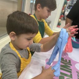 Kids making smoothing out their slime