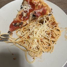 A second plate of spaghetti was so little sauce that grated Romano had to be added for flavor.