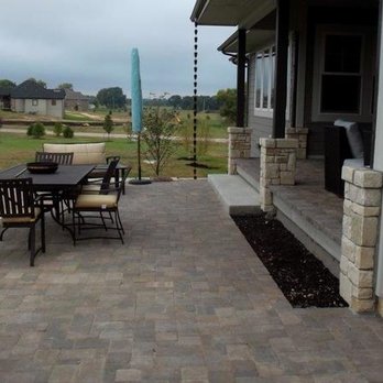 Summit Lawn & Landscape - a patio with a table and chairs - Landscaping Near Me - Grandview, Missouri Summit Lawn & Landscape - a patio with a table and chairs - Landscaping Near Me - Grandview, Missouri