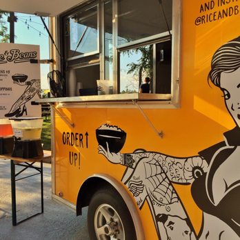 Rice and Beans - a woman in a bikini on the side of a food truck - Food Trucks Near Me Rice and Beans - a woman in a bikini on the side of a food truck - Food Trucks Near Me