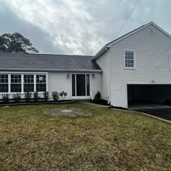 J Serino Inspections - A two-story white house with a dark front door and a two-car garage, featuring a freshly mulched garden bed and a partially b... - Home Inspectors Near Me J Serino Inspections - A two-story white house with a dark front door and a two-car garage, featuring a freshly mulched garden bed and a partially b... - Home Inspectors Near Me