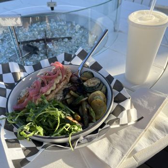 OLD SLO at The Cape - Grilled Salmon plate with mustard dill sauce, savory pickled onions, grilled harvest veggies, and seasoned rice next to an arugula salad. - Salad Near Me - Pismo Beach, California OLD SLO at The Cape - Grilled Salmon plate with mustard dill sauce, savory pickled onions, grilled harvest veggies, and seasoned rice next to an arugula salad. - Salad Near Me - Pismo Beach, California