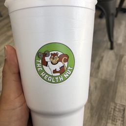 a hand holding a cup of coffee a hand holding a cup of coffee