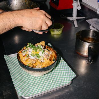 Taco Sublime - a person preparing food in a kitchen - Mexican Near Me - Chicago, Illinois