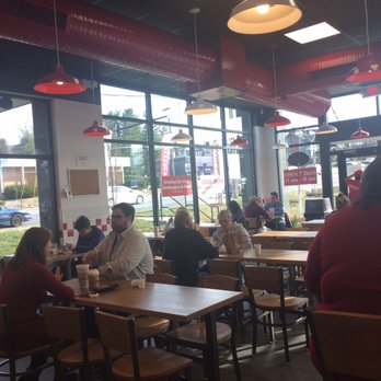Five Guys - a group of people sitting at tables in a restaurant - Burgers Near Me - Asheville, North Carolina