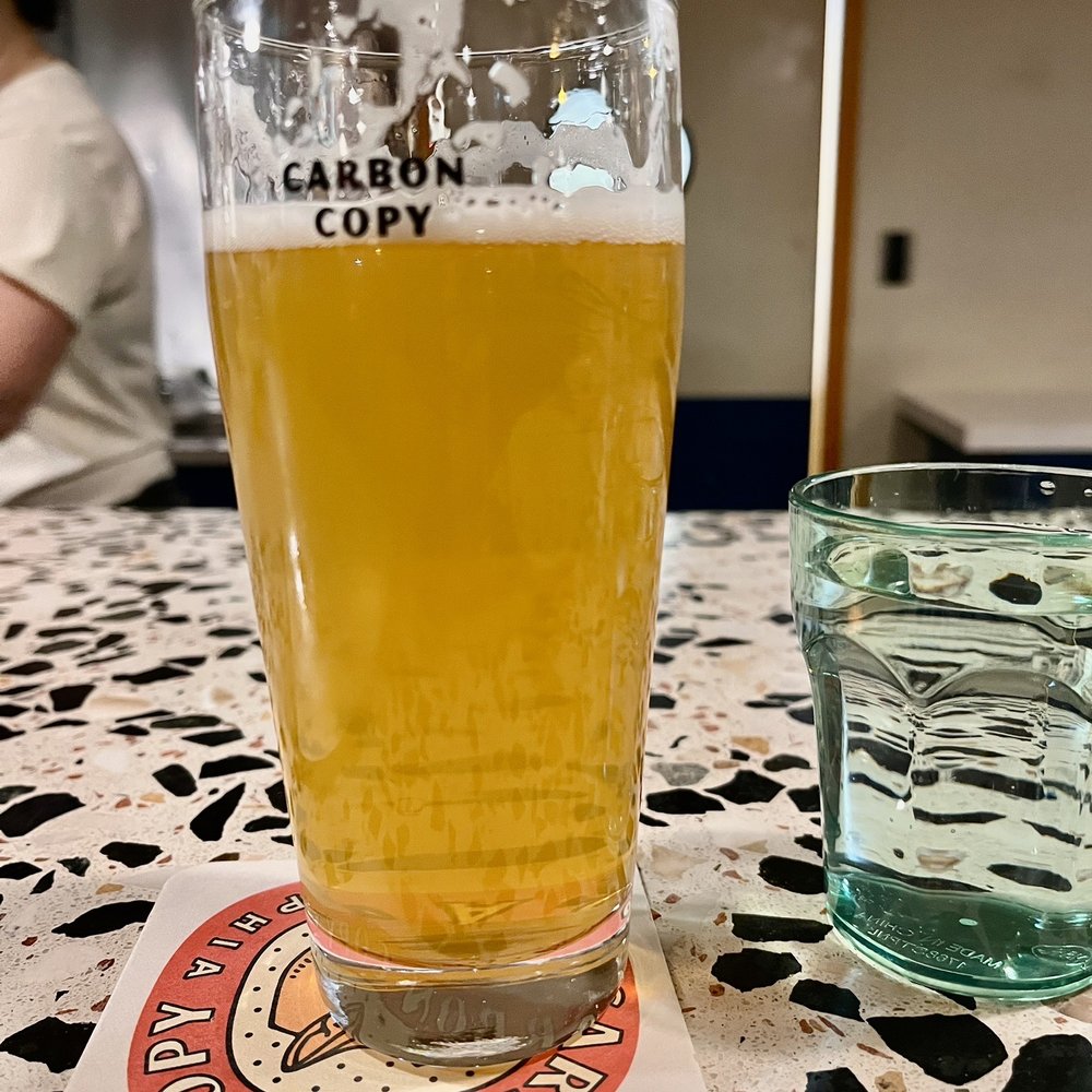 Carbon Copy - a glass of beer on a table - Breweries Near Me - Philadelphia, Pennsylvania