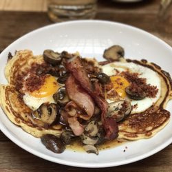 Holybelly 19 - Savory Stack. Pancakes with fried eggs, yummy bacon, homemade Bourbon butter & maple syrup w/ a side of champignons $13