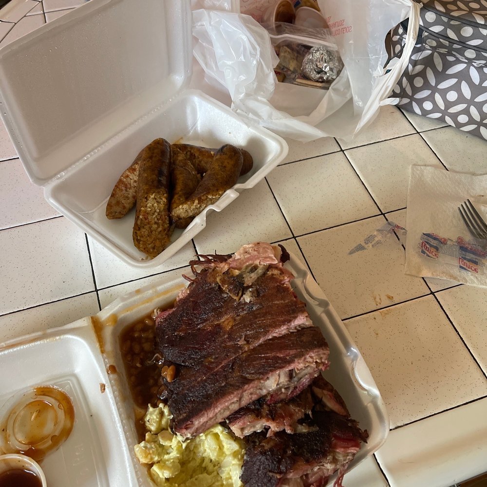 Ribs, sausage, potato salad, boudin, baked beans, and the fixins Ribs, sausage, potato salad, boudin, baked beans, and the fixins