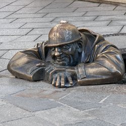 Bratislava's bronze statue named Čumil, also known as "The Watcher" or "Man at Work",