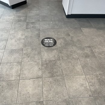 Discount Tire - Wait here stickers placed on the ground for safe 6 ft social distancing - Tires Near Me - Savannah, Georgia