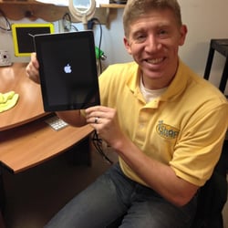 The iShop - Owner at the old location doing iPad repairs for a school