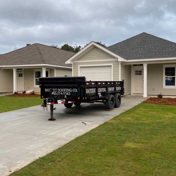 Bayside Roofing - Bayside Roofing Company's trailer in front of a home with a new roof in Panama City Beach, FL - Roofing Near Me Bayside Roofing - Bayside Roofing Company's trailer in front of a home with a new roof in Panama City Beach, FL - Roofing Near Me