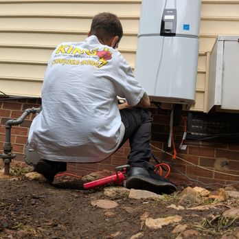 King Electrical Services - A King Electrical Services, Inc. electrician wiring a tankless water heater in Madison, NC, Serving Greensboro, NC and the remaining Triad. - Electricians Near Me - Greensboro, North Carolina