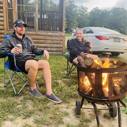 Blackhawk Campgrounds - My husband and daughter by the fire pit outside our cabin rental