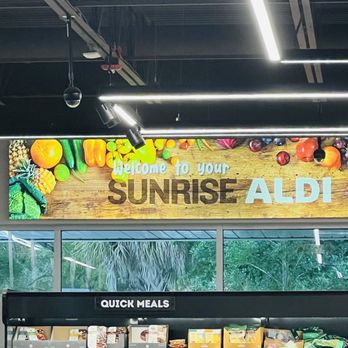 ALDI - Bright signboard at Sunrise ALDI grocery store featuring colorful images of fruits and vegetables and the text 'Welcome to your SUNRISE ALDI.' - Grocery Near Me - Sunrise, Florida