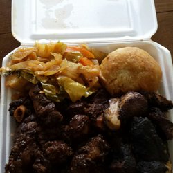Hummingbird Jamaican Cuisine - Medium oxtail with a few pieces of Jerk Pork