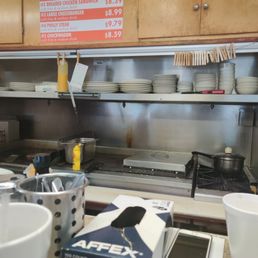a man standing in a kitchen a man standing in a kitchen