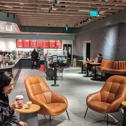 a woman sitting at a table in a coffee shop a woman sitting at a table in a coffee shop