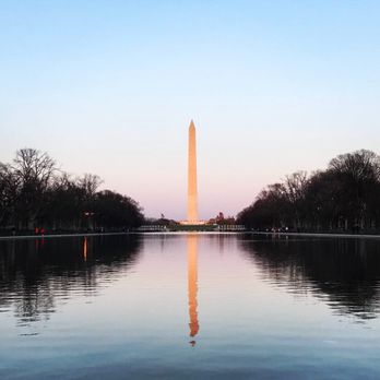 Trip Hacks DC Tours - At the Lincoln Memorial Reflecting Pool facing the Washington Monument as the sun sets. - Walking Tours Near Me