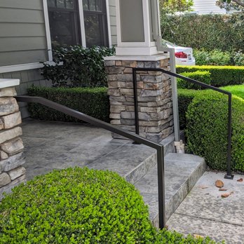 Bay Grab Bar - Front entry twin wrought iron railings installed on slate. Custom powder coat colors to match the brown trim. Safe for visitors, too. - Decks & Railing Near Me