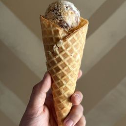 Split scoop waffle cone (top: Peanut Butter Brittle Caramel Fudge, bottom: Bananas Foster with Candied Pecans) Split scoop waffle cone (top: Peanut Butter Brittle Caramel Fudge, bottom: Bananas Foster with Candied Pecans)