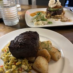 The Berkshire - Front: Bruce County AAA Striploin with their seasonal vegetable corn side   Back: Beer braised pork shoulder